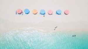 pastel beach umbrellas on Eagle Beach - Aruba Honeymoon