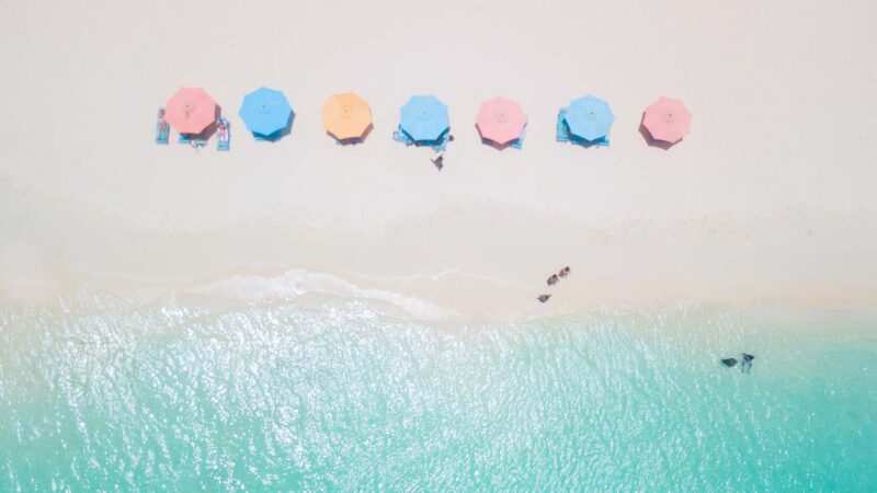 pastel beach umbrellas on Eagle Beach - Aruba Honeymoon