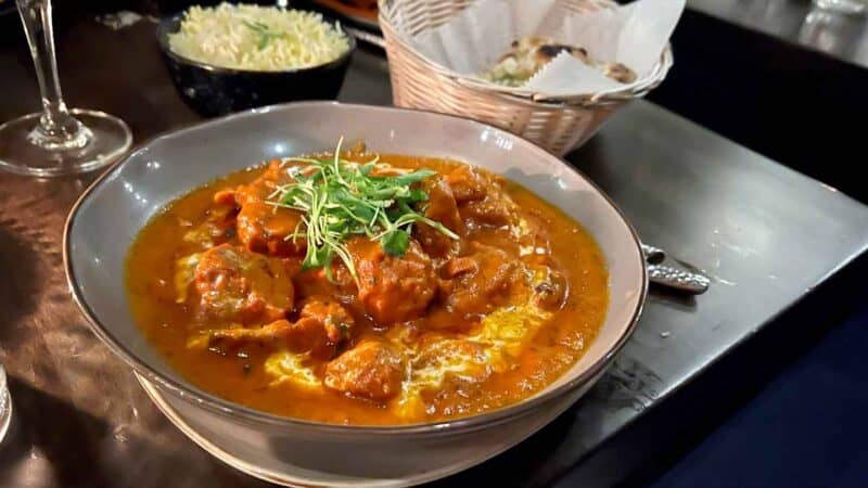 Chicken tikka masala Indian food at restaurant with naan and rice