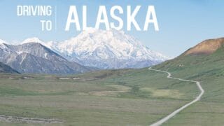 view of the road to the mountains while driving to Alaska - Featured image with white text