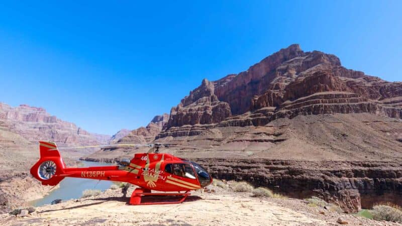 Top 10 Grand Canyon Helicopter Tours 2024- Best & Cheapest 3 Papillon Helicopter Grand Canyon Landing Tour - helicopter parked near the bottom of the Grand Canyon