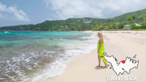 Popular Lorient Beach with woman standing on the white sand in St. Barts