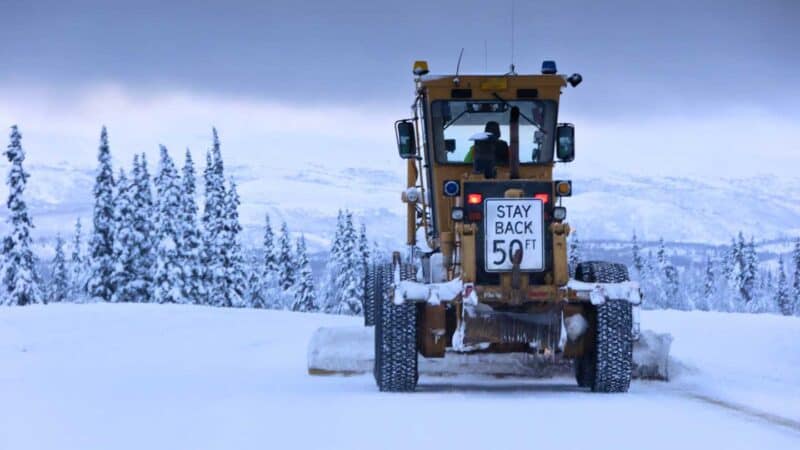 tractor removing the snow on the Alaska Highway during the winter 