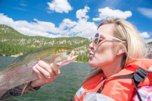 girl kissing a fish in Montana