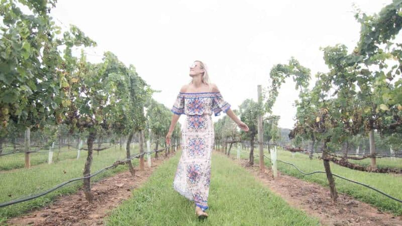 girl walking through vineyards in Yadkin Valley Winston Salem North Carolina