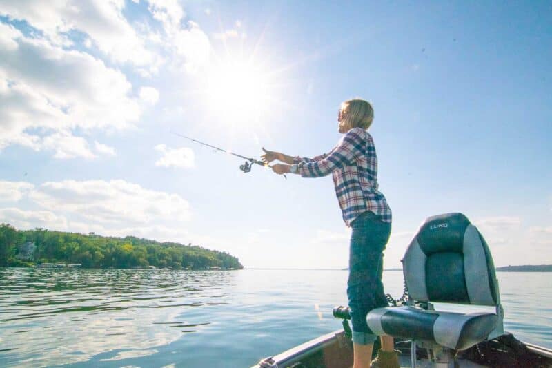 girl casting a fishing pole 