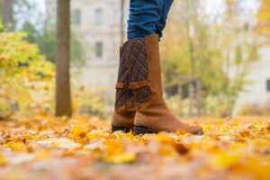 Fall leaves in Germany with a woman wearing Merrell Boots in the leaves