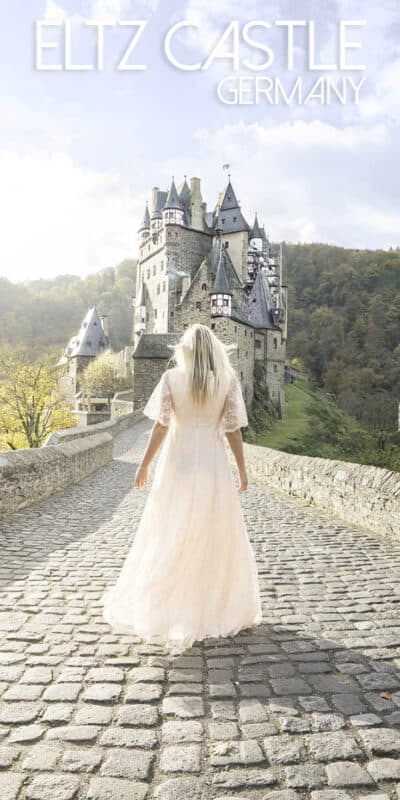 Pinterest pin for Burg Eltz Castle - Woman standing in front of the castle 