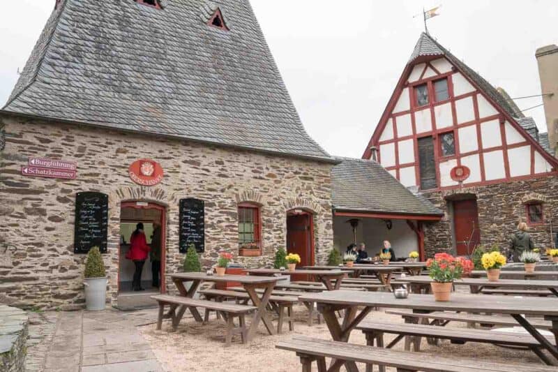 Wooden Tables in front of the Eltz Castle Restaurant inside the castle