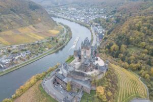 Riverboat on the Moselle River passes the Reichsburg Cochem Castle