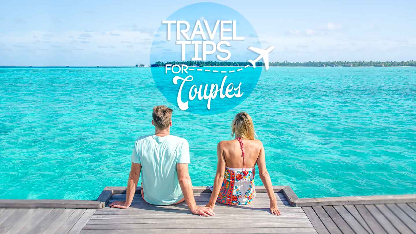 featured image for couple travel tips - couple sitting on the end of a dock in the maldives