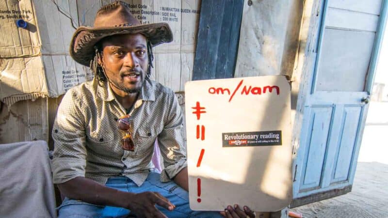 A man teaching visitors a few words of his click language in Namibia - Must do things in Namibia