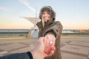 woman with an engagement ring infront of the Milwaukee art museum - Couple travel tips