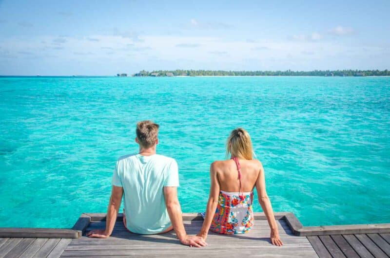 Couple on the end of the dock of Summer Island Maldives during a Maldives Honeymoon