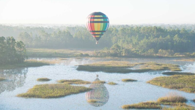 Colorful hot air balloon over water - Orando Balloons - Things to do in Kissimmee - Hot air balloon rides