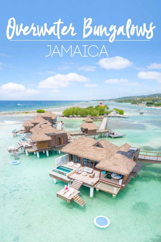 Drone photo showcasing an overwater bungalow at Sandals Royal Caribbean resort in Jamaica - Pin