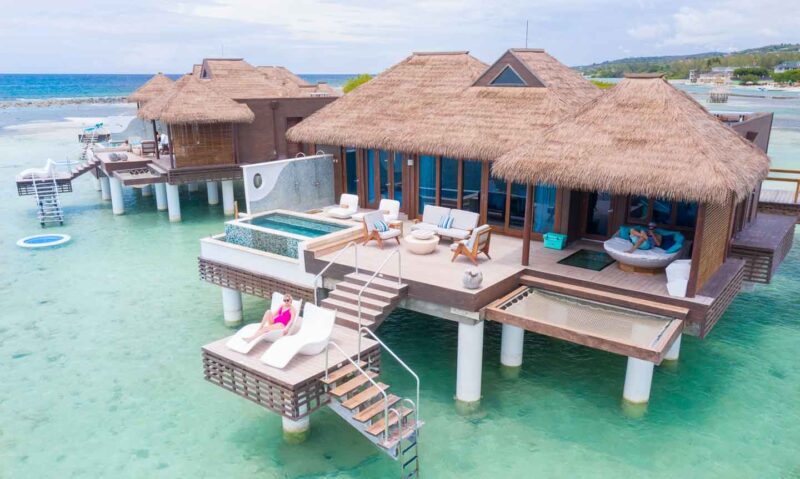 women on deck of overwater bungalow in Jamaica at Sandals Royal Caribbean Resort