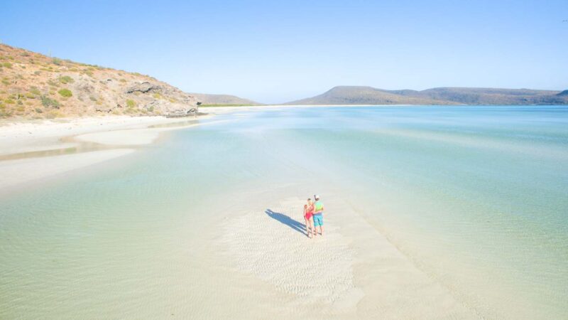 Couple standing on Ensenada Grande Beach in the Baja