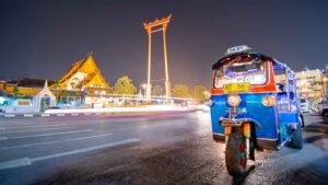 Blue and Red Tuk Tuk motor taxi in Bangkok during a night tour of Bangkok - must do activities in Thailand