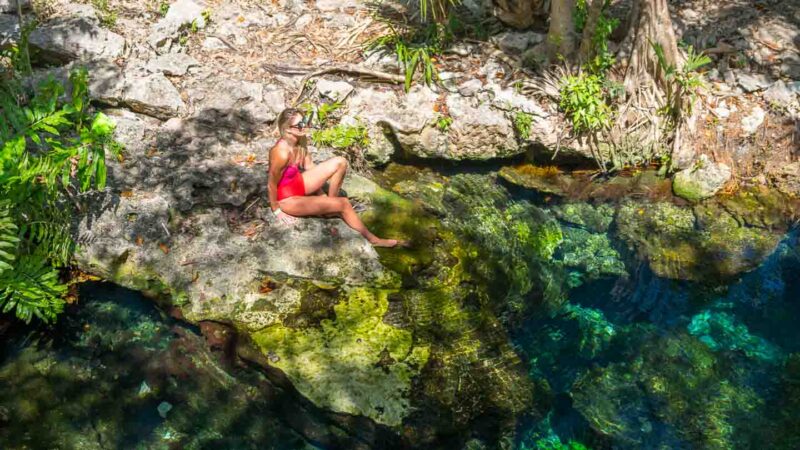 Woman swimming in Cenote El Jardin near Xpu ha