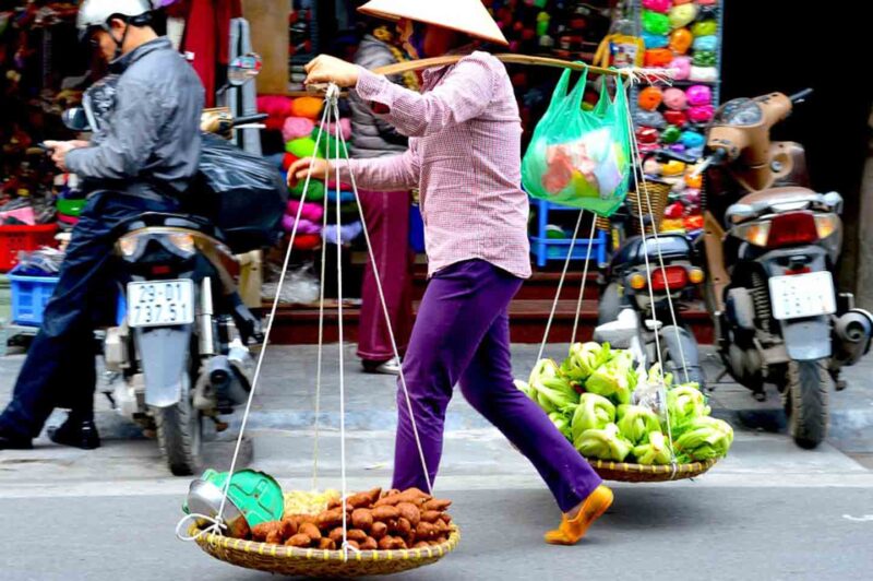 Lady carying street food in Vietnam 