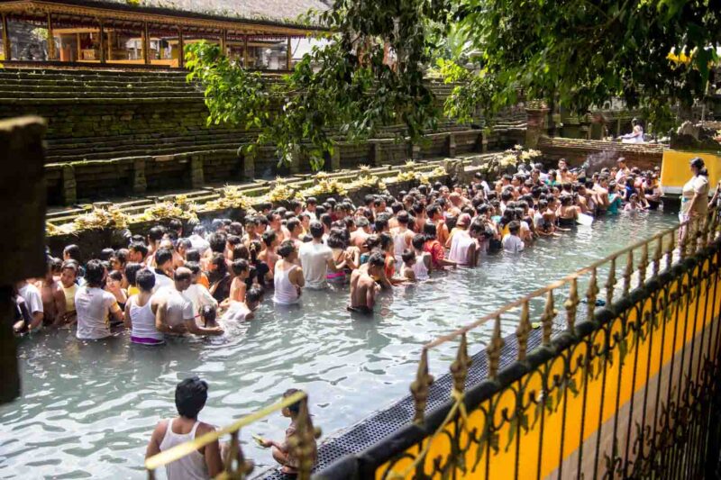 People in the water at the Tirta Empul Temple in Bali