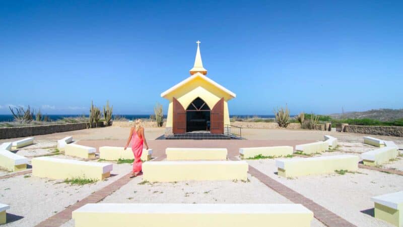 Woman walking toward the Alto Vista chapel and church