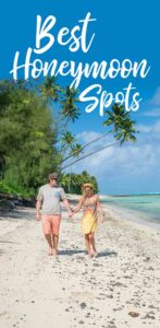 Pinterest pin for best honeymoon spots - Couple standing under palm trees in the cook islands