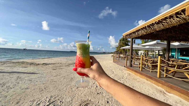 Frozen cocktail drink in a glass on the beach in Jamaica