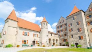 Harburg Castle with light colored stones orange roof and wooden shutters painted orange - top sights along the romantic road in Germany