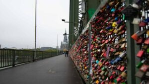 pad locks cover the bridge fence on the main ridge in Koln - Things to see in Cologne