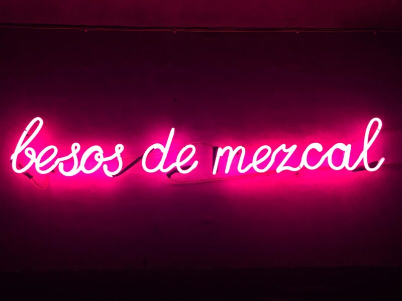 neon pink mezcal sign in Merida 