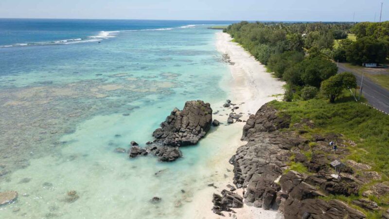 drone photo of black rock beach in Rarotonga - Places to visit in Rarotonga