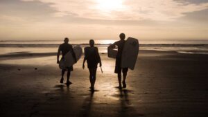 three surfers in Silhouette on the beaches of Costa rica