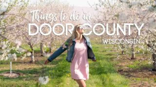 featured image for things to do in Door County - Woman standing in a cherry orchard in bloom