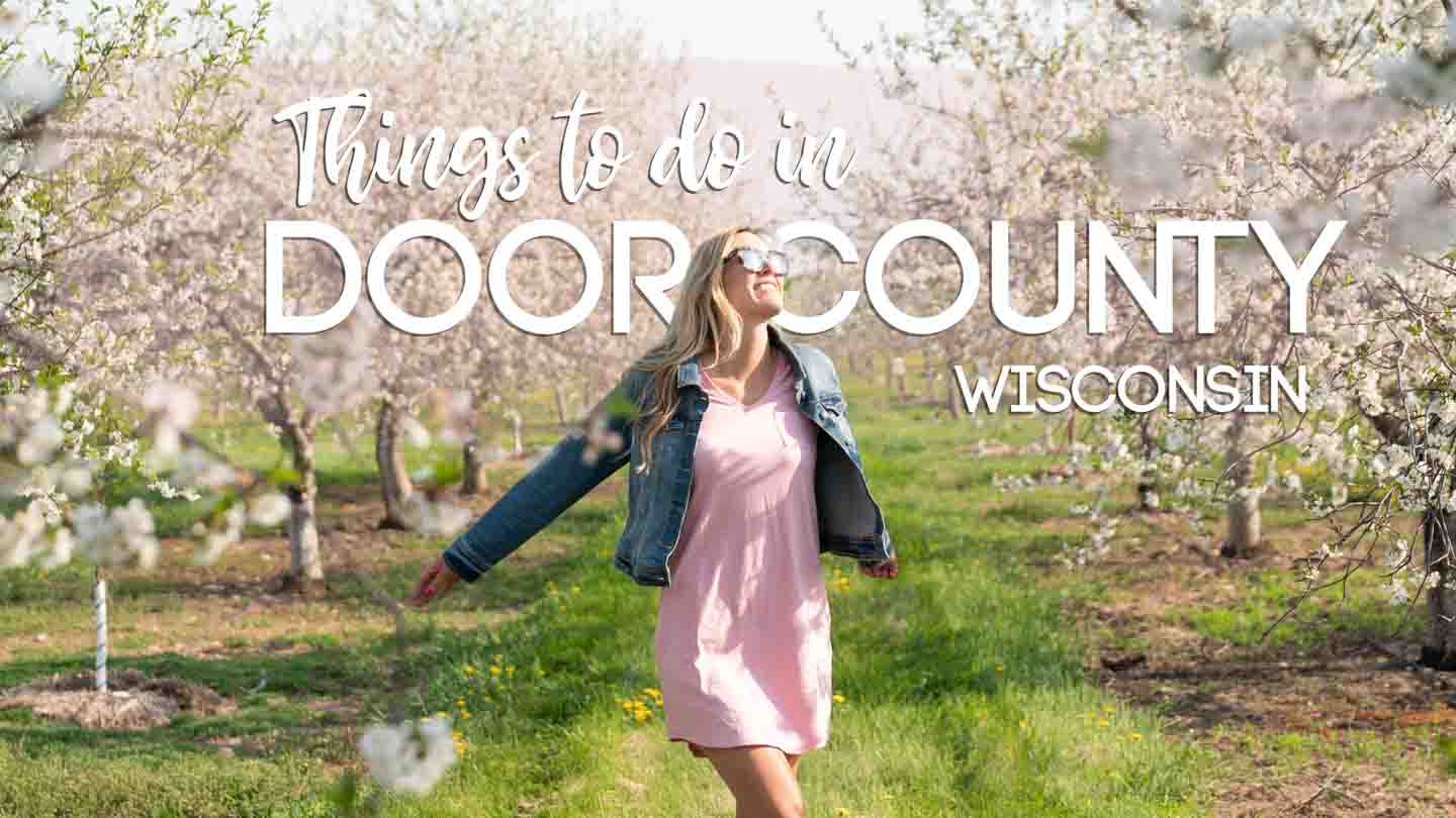 featured image for things to do in Door County - Woman standing in a cherry orchard in bloom