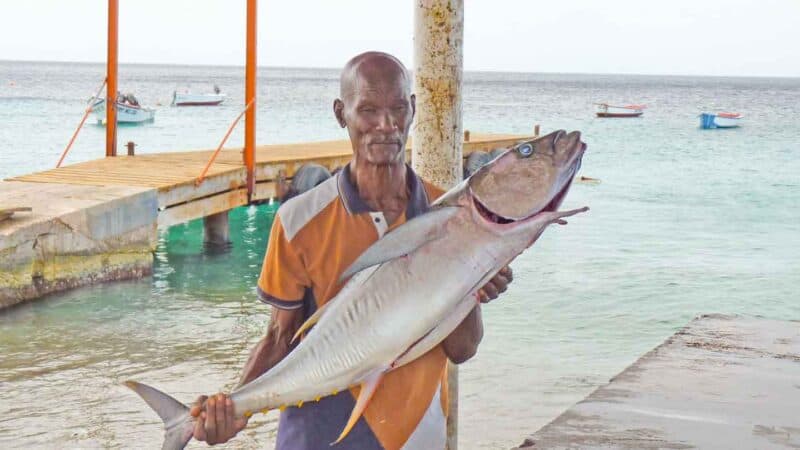 Man with fresh fish from Play Grandi beach in Curacao