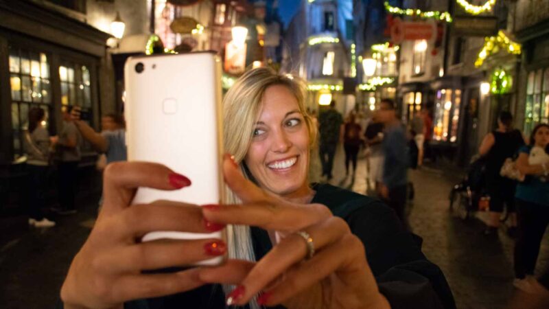 woman using the Universal Orlando Resorts App in diagon Alley