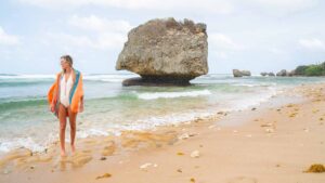 Woman standing at Bathsheba Beach and rock formations in Barbados - Top Caribbean Islands