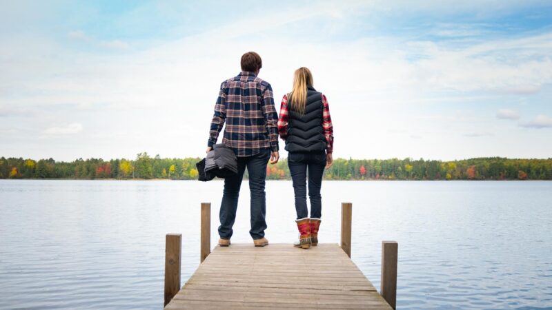 Couple standing on a dock at a Lake Resort in Wisconin