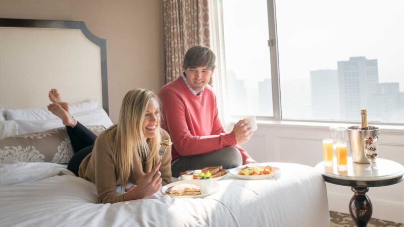 couple eating breakfast in bed at the Fairmont San Francisco