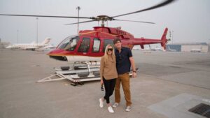 couple standing in front of a helicopter in San Francisco