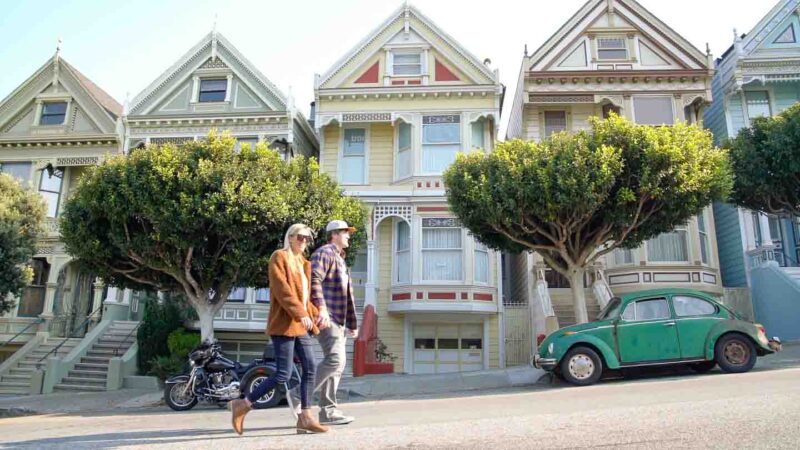 Couple walking past the painted ladies in San Francisco - Historic Homes - San Francisco Itinerary