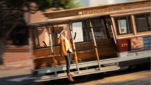 how to get around San Francisco on a weekend visit - Woman on a cable car