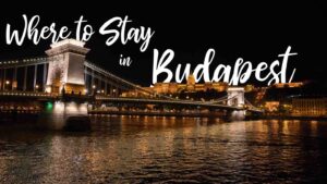 chain bridge at night with text - Where to stay in Budapest - featured image for accommodation guide to Budapest