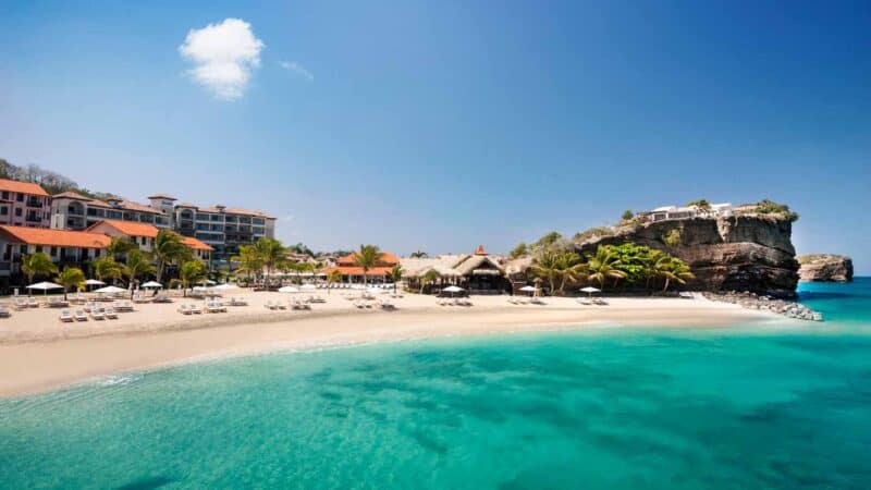 View of Sandals Grenada with aqua water and white sand beaches with the resort property set in the background - Best Sandals Resort Property