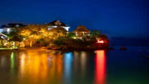 Sandals Ochi at night - resort light reflecting off of the water - best nightlife of Sandals Resorts