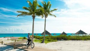 Staff memeber riding a bike on the dock at Sandals Royal Bahamian Luxury Resort - Best Resort for Spa services