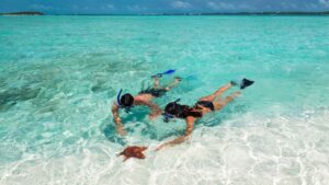 couple swimming in the Caribbean at a Sandals Resort
