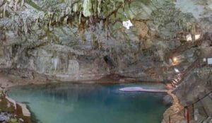 Wide Photo of Cenote Suytun near Valladolid Mexico - Large open cave with formations and large but shallow pool of water